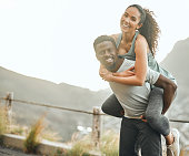 istock Shot of a young man giving his girlfriend a piggyback ride 1372307830