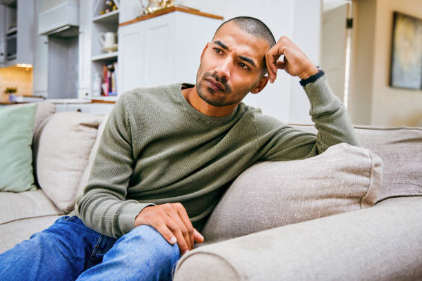 Shot of a young man relaxing at home stock photo