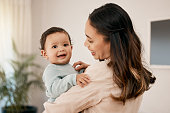istock Shot of a young mother bonding with her adorable baby at home 1390160518