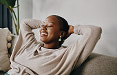 istock Shot of a young woman relaxing on the sofa at home 1337405825