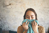 istock Shot of a young woman smelling freshly washed laundry at home 1330301423