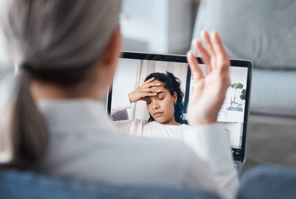 Shot of an unrecognisable psychologist sitting and using a laptop for an online consultation with her patient Stressing doesn't help with anything online psychology stock pictures, royalty-free photos & images