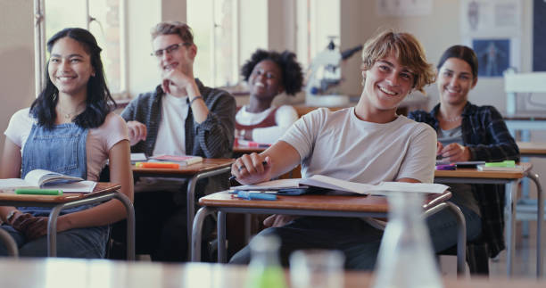 Shot of students laughing during a lesson in a classroom Their teacher knows how to make learning fun high schools stock pictures, royalty-free photos & images