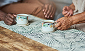 istock Shot of two unrecognizable people sharing a cup of coffee 1316076405