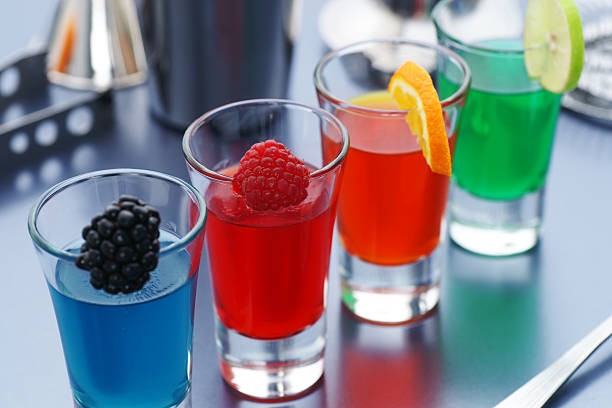 Shots mixed with different fruits "Four colorful jello shots with fresh fruit garnishes.Same shot vertically, and a bunch of other drinks you desperately need:" gelatin dessert stock pictures, royalty-free photos & images