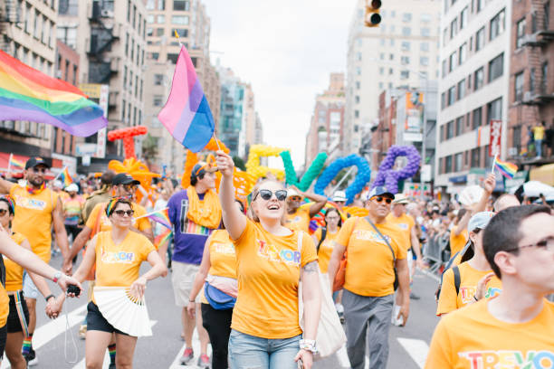 Shots of the Pride Parade 2019 New York, NY, USA - June 30, 2019: Group of TREVOR supporters walking the parade route waving Pride flags nyc pride parade stock pictures, royalty-free photos & images