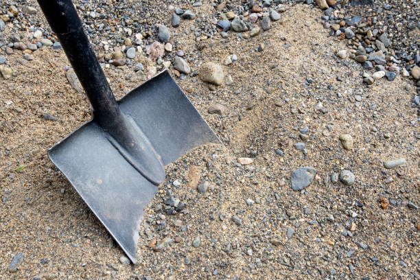 Shovel placed on sand for construction stock photo