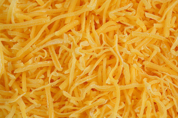 Shredded cheddar cheese stock photo