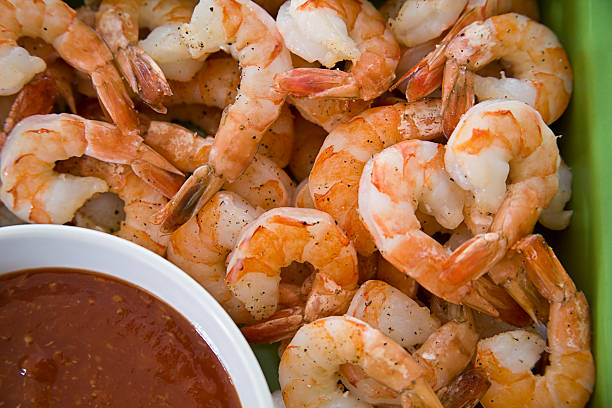 Shrimp and Sauce Close up of shrimp with cocktail sauce.  Other variations available. shrimp cocktail stock pictures, royalty-free photos & images