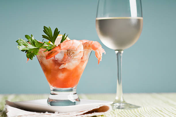 Shrimp Cocktail And White WIne Shrimp cocktail appetizer with a glass of white wine. cocktail sauce stock pictures, royalty-free photos & images