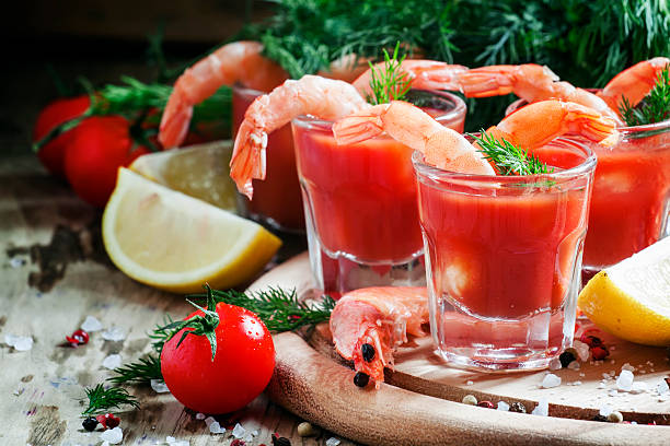 Shrimp cocktail in small glasses, cherry tomatoes stock photo