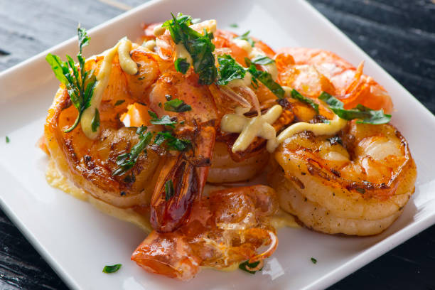 Shrimp sautéed in organic butter, garlic and served  with jumbo lump crab cake, cauliflower, broccoli and potatoes. Classic American restaurant or French bistro entree favorite. stock photo