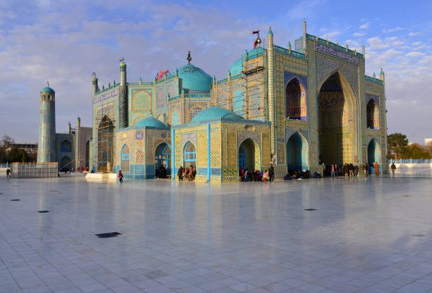Shrine of Ali (Hazrat Ali Mazar) with pilgrims resting, Mazar-i-Sharif, Balkh province stock photo