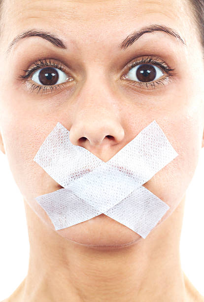 Shut up! http://i1364.photobucket.com/albums/r725/hofi99/UJBANNER2/andrea_banner_zps2cf1a621.jpg human mouth gag adhesive tape women stock pictures, royalty-free photos & images