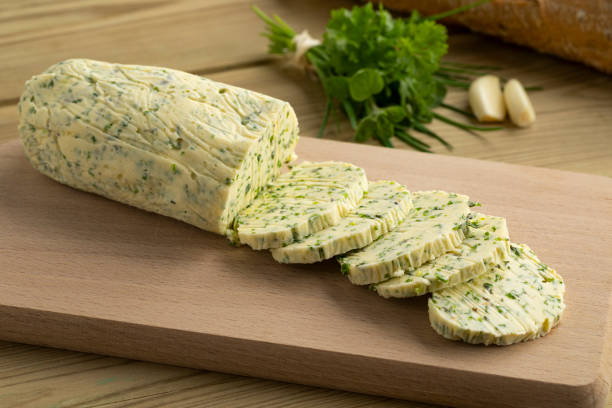 Siced herb butter close up stock photo