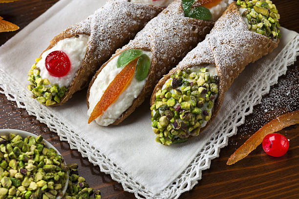 Sicilian Cannoli 3 Three sicilian cannoli with ingradients on wooden table cannoli stock pictures, royalty-free photos & images