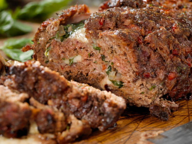 sicilian style rolled meatloaf with deli ham, basil and mozzarella - meat loaf imagens e fotografias de stock