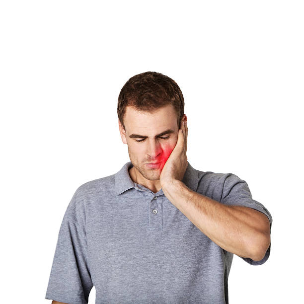 sick man touching his cheek with a hand - abces stockfoto's en -beelden