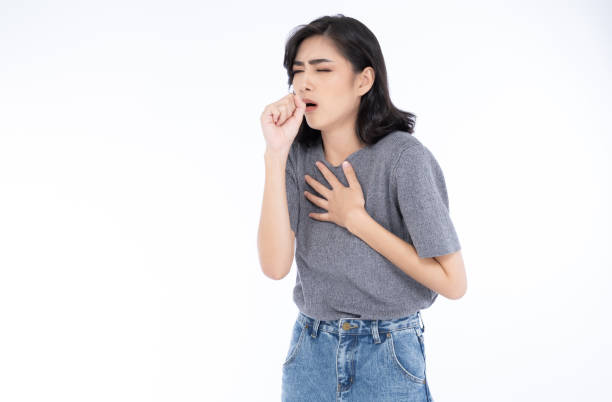 Sick young Asian woman in grey t-shirt and jeans feeling unwell and coughing as symptom for cold or bronchitis. Woman have symptoms of COVID-19. Healthcare concept. Sick young Asian woman in grey t-shirt and jeans feeling unwell and coughing as symptom for cold or bronchitis. Woman have symptoms of COVID-19. Healthcare concept. hot arab woman stock pictures, royalty-free photos & images