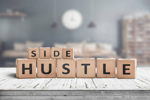 Side hustle sign on a plank table stock photo