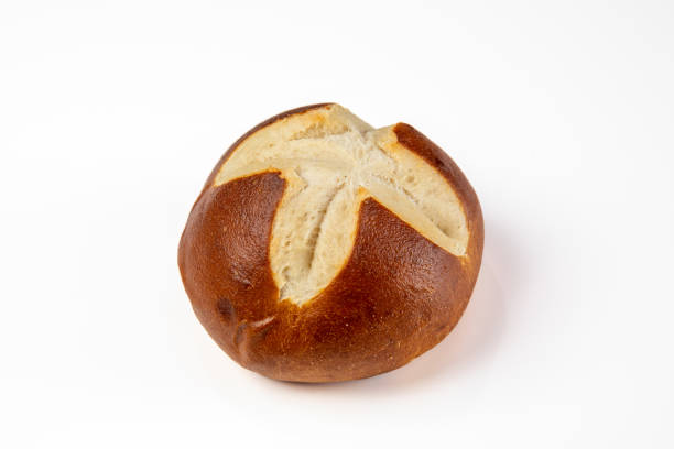 Side View of a Single Pretzel Roll on a White Table stock photo