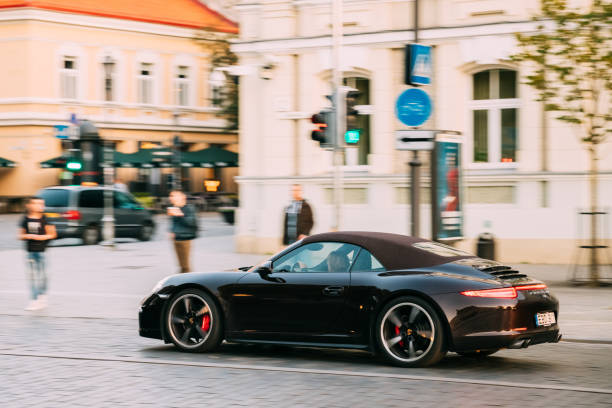 Side View Of Black Porsche 991 Targa 4S Car Moving On Street. Ca Vilnius, Lithuania - September 29, 2017: Side View Of Black Porsche 991 Targa 4S Car Moving On Street. Car Of Second Generation porsche 911 stock pictures, royalty-free photos & images