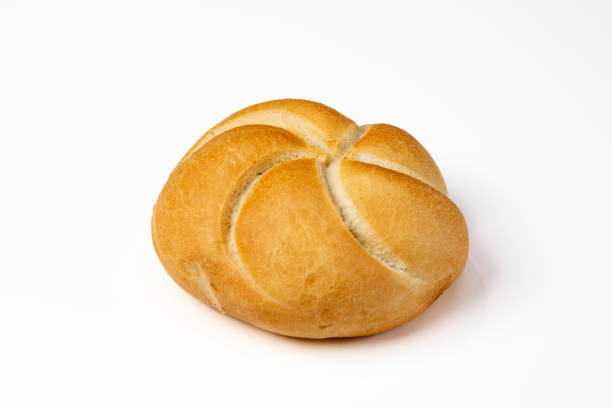 Side view of Kaiser roll on white table. stock photo