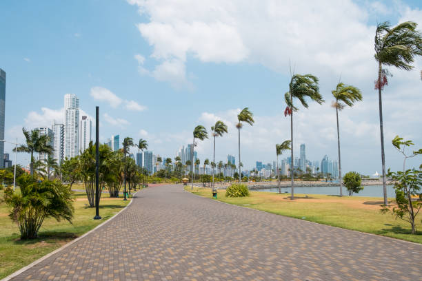 Sidewalk at public park with city skyline at coast promenade in Panama City - stock photo