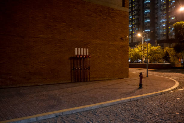 A sidewalk in a brick building at night stock photo