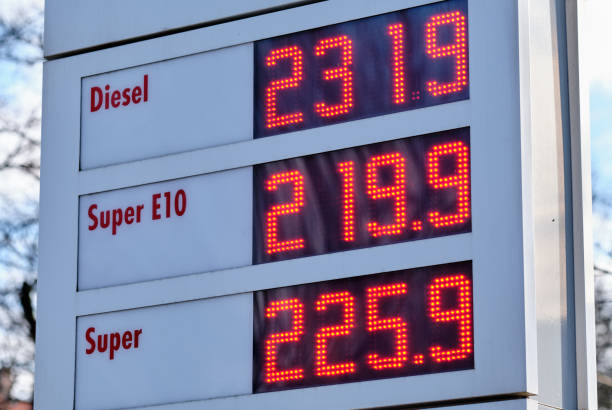 Sign at a gas station showing extremely high gasoline prices stock photo