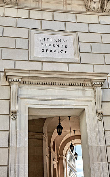 Sign Engraved on the Wall of the Internal Revenue Service Washington DC, United States - October 2, 2016: Engraved Internal Revenue Service Sign on the Wall of the IRS Building on the 12th Street side of building. irs stock pictures, royalty-free photos & images