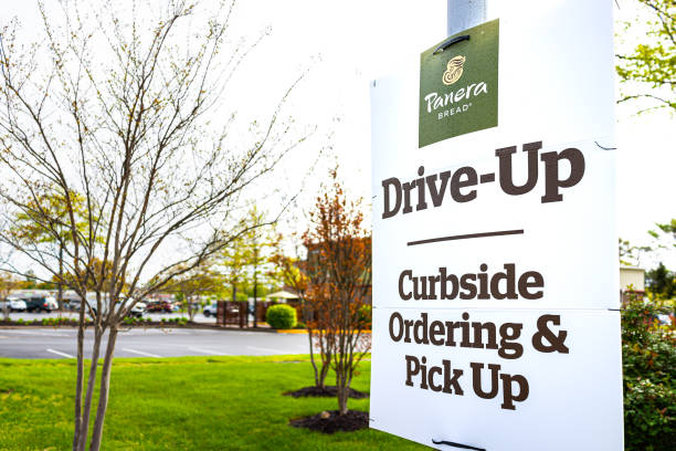 Sign for open Panera restaurant for take-out curbside pick-up during coronavirus covid-19 epidemic Herndon, USA - April 27, 2020: Virginia Fairfax County street sign for open Panera restaurant for take-out curbside pick-up during coronavirus covid-19 epidemic or pandemic curbsidepickup stock pictures, royalty-free photos & images