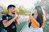 istock Sign language: 2 hispanic and african american student friends deaf  talking with nonverbal communication. 1341298218