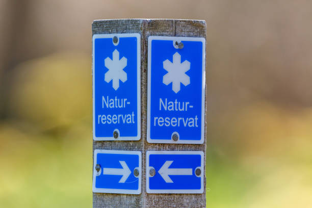 Sign on a wooden post for a nature reserve in Sweden Sign on a wooden post for a nature reserve in Sweden nature reserve stock pictures, royalty-free photos & images