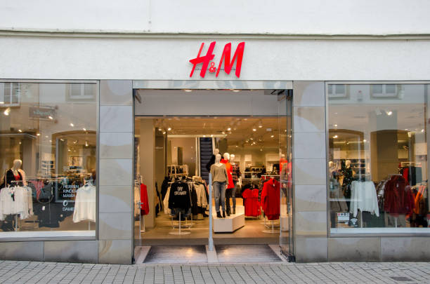 H&M sign on the wall. H&M Hennes & Mauritz AB is a Swedish multinational clothing-retail company, clothing for men, women, teenagers and children. stock photo