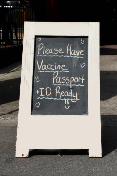Sign requiring proof of full vaccination plus ID in order to dine inside. Sign at entrance of restaurant in Ontario, Canada stating proof of full vaccination plus ID is necessary to dine inside. vaccine mandate stock pictures, royalty-free photos & images