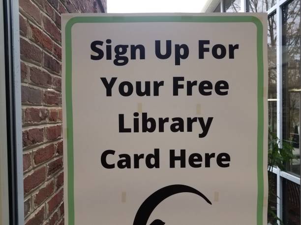 sign up for free library card here sign on window with arrow stock photo