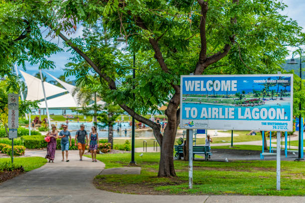 Sign welcoming tourists to Airlie Lagoon. stock photo