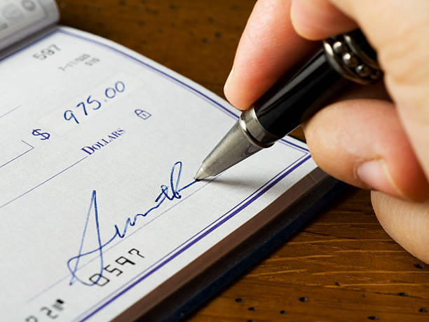Signing a Check stock photo
