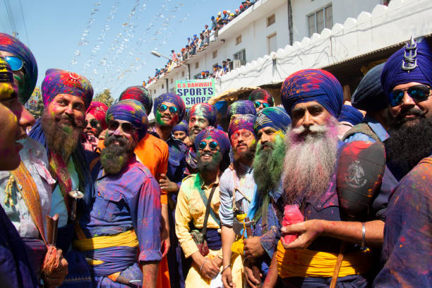 Sikh devotees celebrating colorful holi during Holla Mohalla Festival at Anandpur Sahib in Punjab, India on March 19, 2019. Selective Focus, Blur Background. holla mohalla stock pictures, royalty-free photos & images