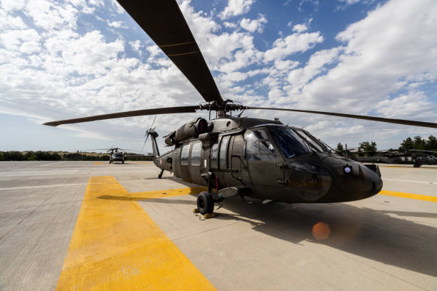 UH-60 Sikorsky Black Hawk military helicopter on heliport UH-60 Sikorsky Black Hawk military helicopter on heliport military helicopter stock pictures, royalty-free photos & images