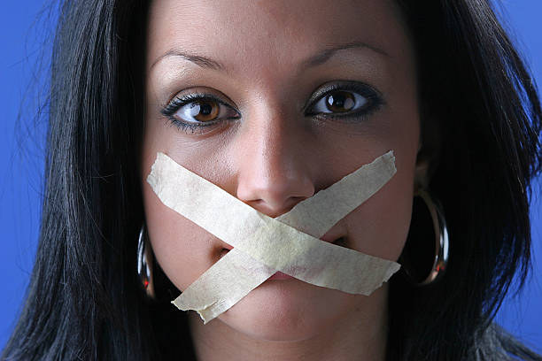 Silence Girl with a taped mouth human mouth gag adhesive tape women stock pictures, royalty-free photos & images