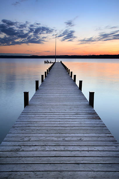 Silent Place woman sitting in meditation at the end of the jetty jetty stock pictures, royalty-free photos & images