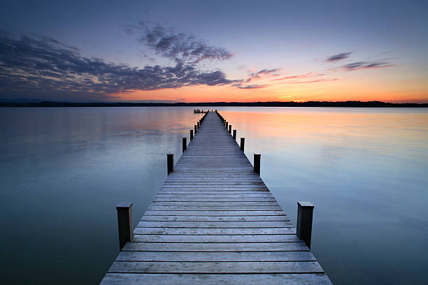 Silent Place woman meditating at the end of the jetty jetty stock pictures, royalty-free photos & images