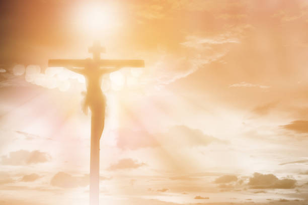 silhouette jésus christ crucifixion sur la croix sur le fond de lumière de coucher du soleil orange, la prière et le concept de religion de louange - good friday photos et images de collection
