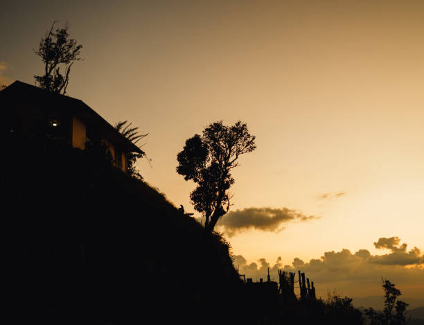 Silhouette, mountain house, light of the sun stock photo