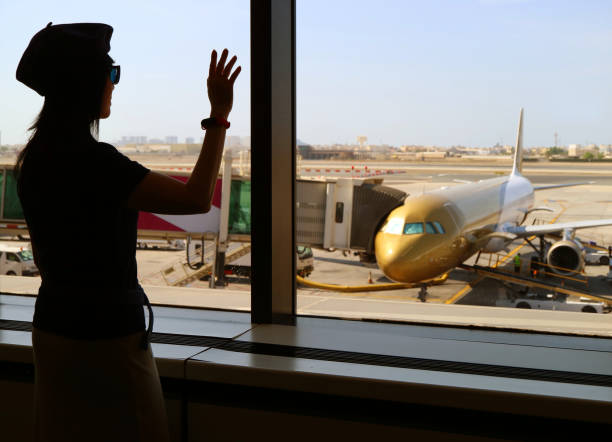 Silhouette of a woman waving hand to the airplane at the airport  wave goodbye asian stock pictures, royalty-free photos & images