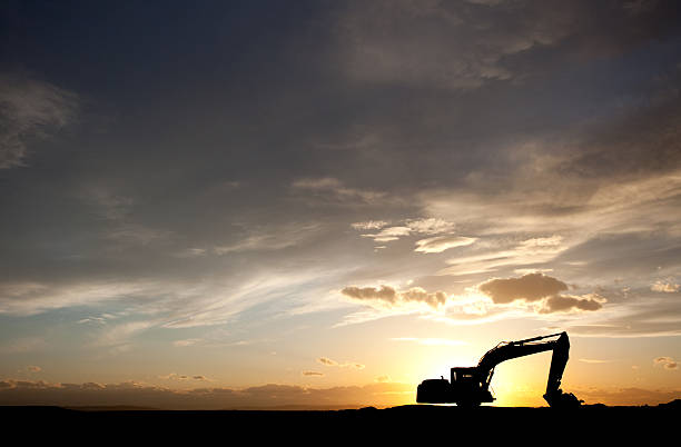 Silhouette of Bulldozer at a Construction Site stock photo
