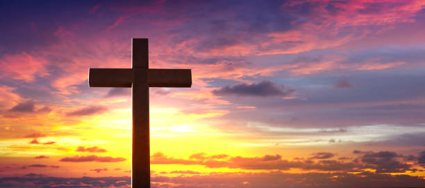 Silhouette of crucifix cross at sunset sky.  good friday stock pictures, royalty-free photos & images