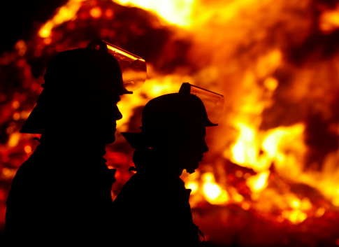 silouette of firefighters against large fire in the dark, SOFT FOKUS